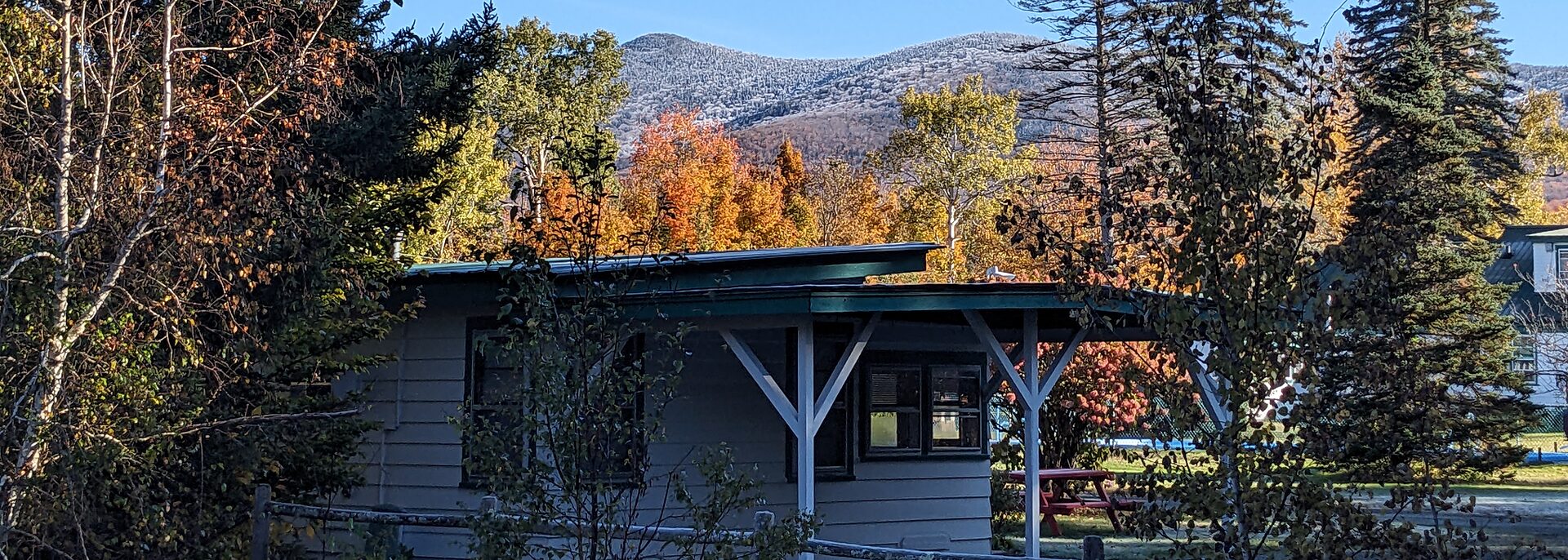 Cabin exterior with fall foliage and mountain view